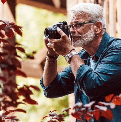 older man holding camera
