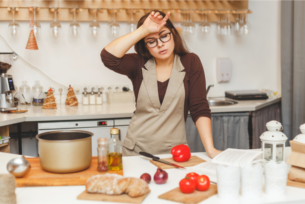 Woman looking exhausted in the kitchen.